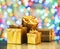 Golden gift boxes as a symbol of wishes and celebration. Colorful blurred bokeh background
