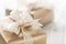 Golden gift boxes with beautiful ribbon and bow on a bright shiny background