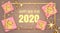 Golden gift or present boxes, 2020 numbers happy new year template with Christmas decorations in pink background top view and