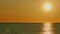 Golden Glare On Water Abstract Background. Sunset At Sea. Ocean Colors Sky And Waves In Red Color. Slow motion.