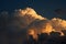 GOLDEN GLOW ON BILLOWING CUMULUS CLOUD