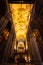Golden glowing ceiling beams extend through church
