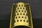 Golden grater on black stone background