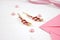 Golden hairpins with pink gemstone and pink ribbon on pink background