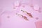 Golden hairpins with pink gemstone and pink ribbon on pink background