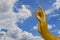 Golden hand of Guanyin statue with cloud and blue sky