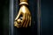 Golden hand holding a door knob