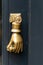 Golden hand holding a door knob