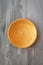 Golden handmade painted wooden plate on grey background