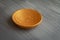 Golden handmade painted wooden plate on grey background