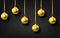 Golden  hanging Christmas balls isolated on black  background