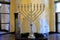 Golden Hanukkah menorah in the synagogue for Jewish holiday. Ancient ritual religious menorah candle