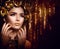 Golden holiday makeup. Fashion art hairstyle, manicure and makeup