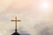 Golden holy cross on chapel roof with spiritual sky background,