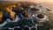 Golden Horizons: Captivating Aerial View of a Rocky, Rugged Coastline at Sunset