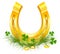 Golden Horseshoe and coins on grass clover. Patricks Day symbols