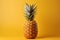 Golden hued pineapple, soft yellow backdrop, ideal for text placement