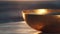 The golden hues of a meditation bowl glow warmly in the tranquil light of sunset, evoking a sense of calm and