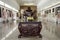 The golden incense pot in front of the marble laughing Buddha statues