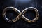 a golden infinity symbol on a black marble background