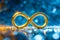 Golden infinity symbol sign on glowing blue space background with bokeh