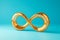 Golden infinity symbol sign on light blue background