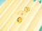 Golden jewelry ring fashion accessories on yellow pastel paper fan background