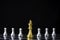 Golden king chess in front of silver pawn chess on chess board and black background. Leadership and teamwork concept