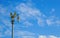 Golden Kinnaree on light pole sky cloud. Lamp sculpture half-bird half-woman