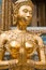 Golden Kinnari statue at Temple of Emerald Buddha. Bangkok, Thailand