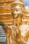 Golden Kinnari statue at Temple of Emerald Buddha. Bangkok, Thailand