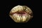 Golden kiss. Gold lips. Gold paint from the mouth. Golden lips on woman mouth with make-up. Sensual and creative design