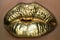 Golden kiss. Golden lipstick on lips, female gold mouth. Imprint lips.