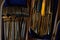 Golden knives spoons and forks in wooden tray on table