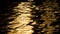 Golden light reflecting on sea, lake or river water with liquid gold ripples and reflections