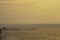 Golden light of sunrise behind the mountains in the sea and the shadow of the wooden bridge at  Trat in Thailand