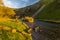 The golden light at sunset illuminates the River Dove at Dovedale, UK