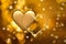Golden lights in the shape of hearts in the defocus on a dark background. Celebrating Valentine`s Day,gold blurred background with