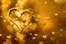 Golden lights in the shape of hearts in the defocus on a dark background. Celebrating Valentine`s Day,gold blurred background with