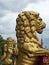 Golden lion statues in profile decorating the historic rochdale town hall against a dramatic sky with town flag in the distance