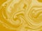 Golden liquid marbling paint texture background abstract with a color mix of yellow and white