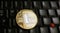 Golden Litecoin LTC  coin over  a black laptop  keyboard