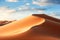 Golden Majesty: Sahara\\\'s Endless Dunes Under Azure Sky