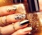 Golden manicure with gems and sparkles. Bottle of nailpolish, trendy accessories