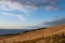 Golden meadow view with pacific ocean at behind