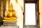 Golden meditating buddha next to opening door at Wat Phutthaisaw