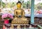 A golden meditating buddha statue in Bhutan style