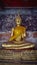 Golden Meditating Buddha Statues Sitting In Corridor