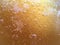 Golden melted sugar background with bubbles