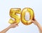 Golden metal balloon number fifty 50. party decoration with Golden balloons. The number 50 is in your hand.Anniversary sign for a